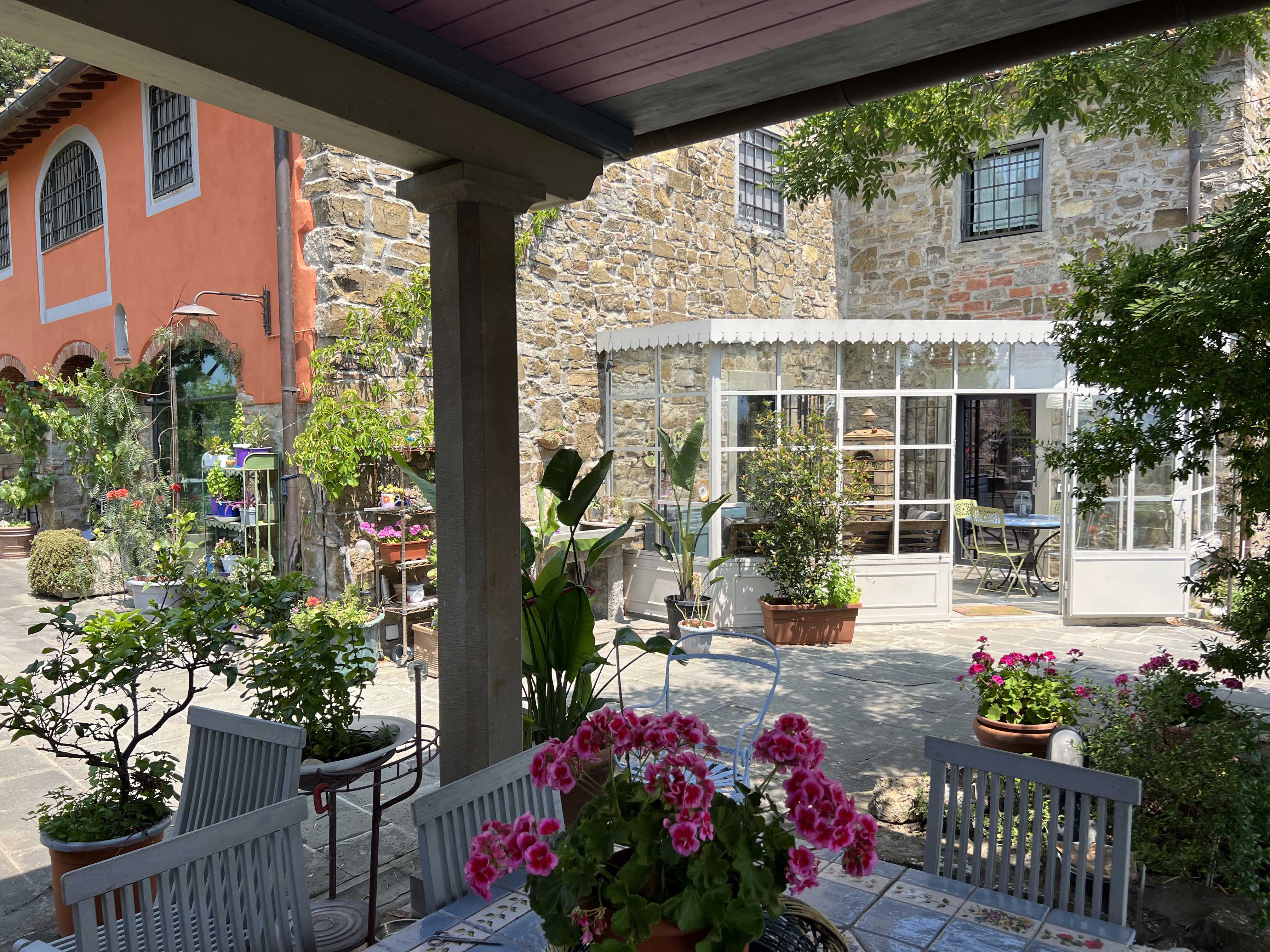 Charming villa courtyard with greenhouse