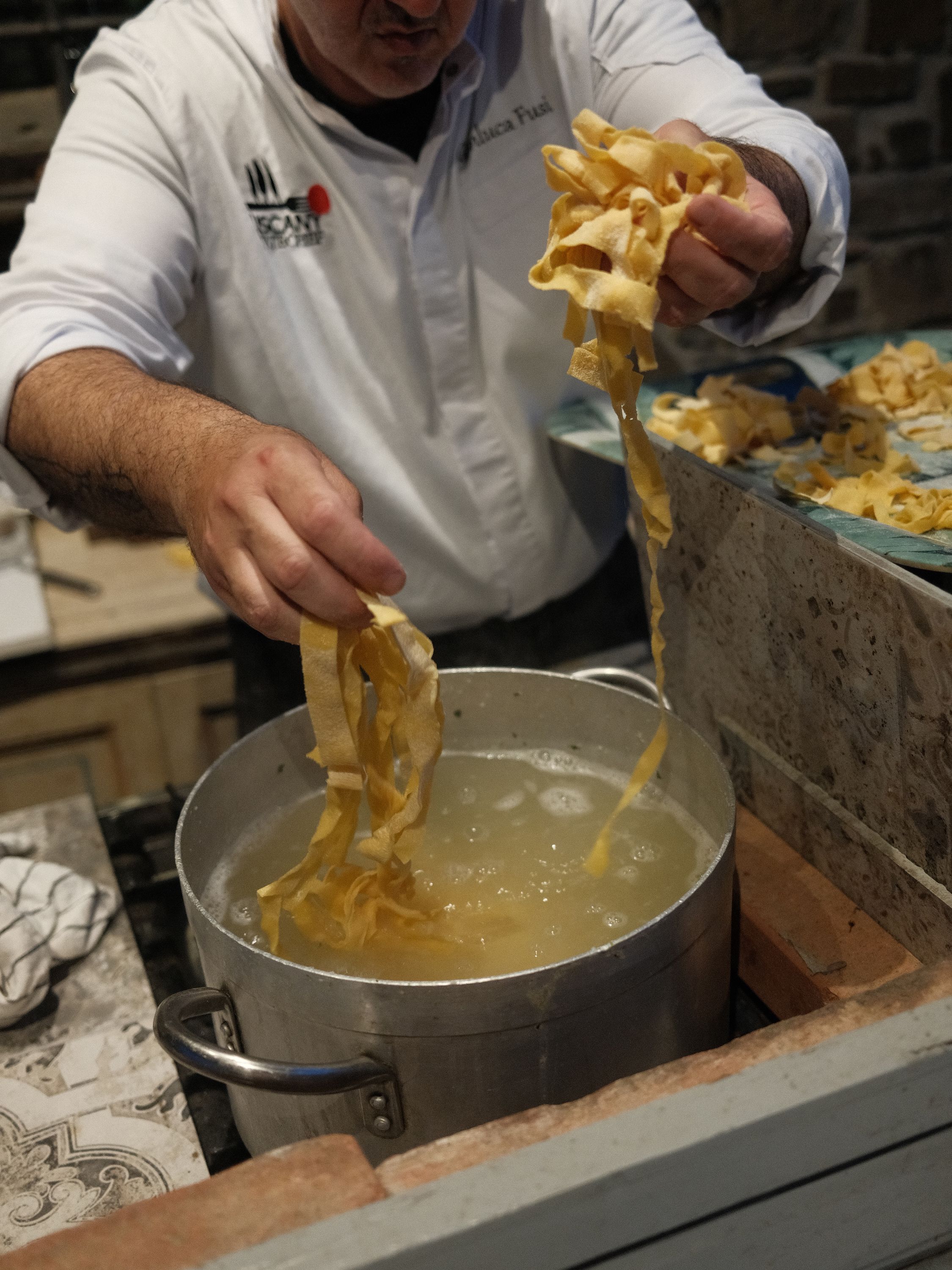 Our chef dropping fresh pappardelle at the cooking class